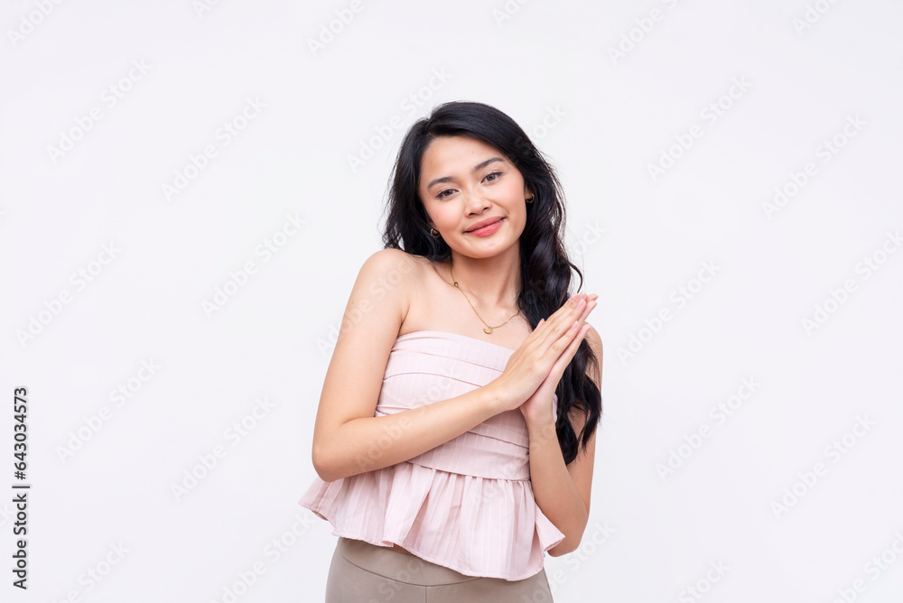 A pretty and friendly young asian woman makes a request while looking cute. Asking for something. Isolated on a white background. A pretty and friendly young asian woman makes a request while looking cute. Asking for something. Isolated on a white background.