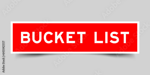 Red color square label sticker with word bucket list on gray background