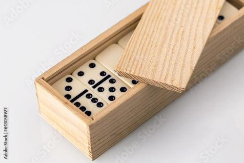 domino tiles stacked in a wooden box