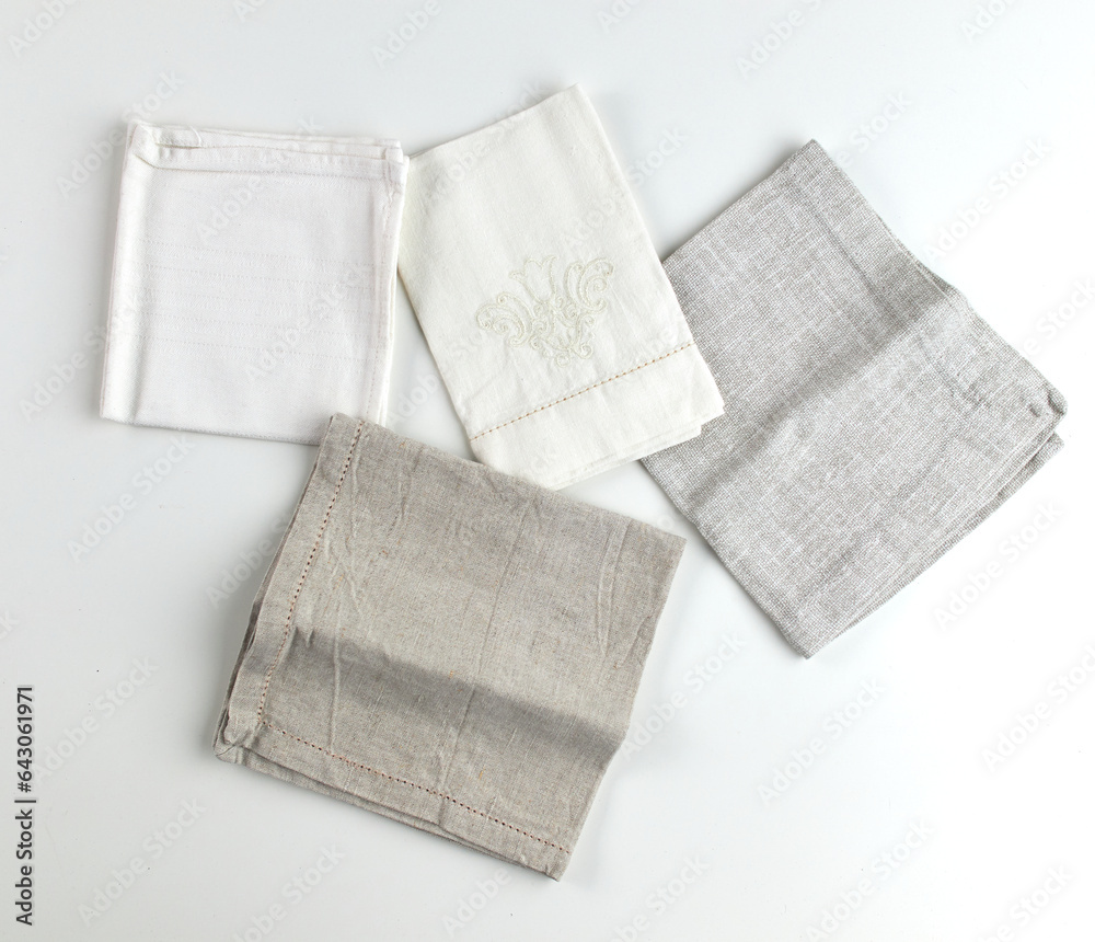 Napkins and towels on white background. Kitchen textiles, top view