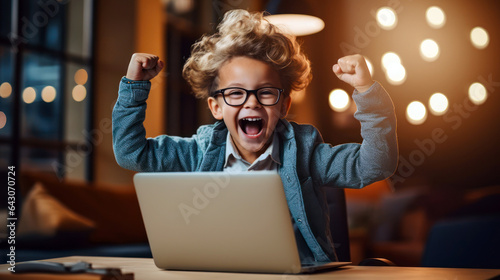 tech-savvy kid in a jacket and stylish glasses sits in front of a computer