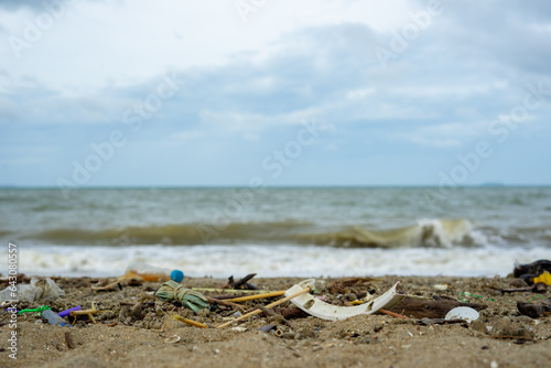 Trash on the beach can consist of plastic bottles, bags, wrappers, cans, cigarette butts, fishing nets, and other items that people leave behind or discard in the ocean.