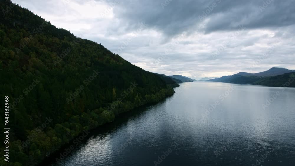 Flying Over Scotland Lake Near Silhouetted Hill Flying Over Scotland Lake Near Silhouetted Hill