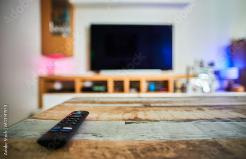 Streaming remote control on a table in a blurred living-room photo