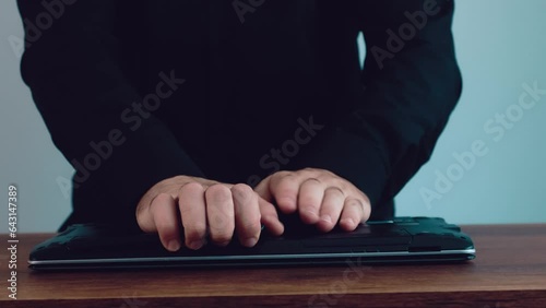 man in black shirt opening laptop and changing ram photo