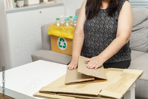 Home recycle eco zero waste concept Woman using recycle paper box. Stacking brown cardboard box eco friendly packaging made of recyclable raw materials.