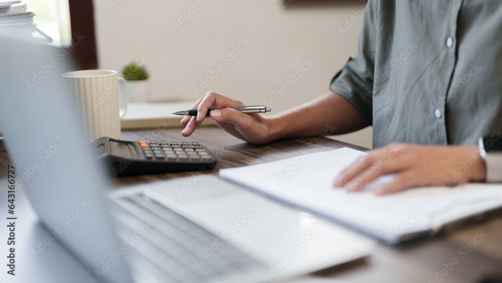 Female calculating personal financial for future plan at her home, taxes payment.. Female calculating personal financial for future plan at her home, taxes payment..