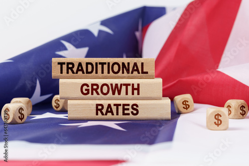 On the US flag and wooden plates with the inscription - traditional growth rates photo