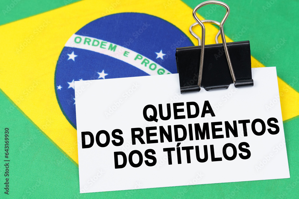 On the flag of Brazil lies a business card with the inscription - falling bond yields