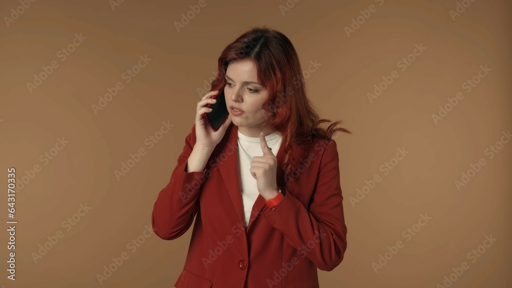 Medium isolated shot of a relaxed and serious young woman calmly talking on her phone, agreeing and arranging a possible meeting, explining something. Medium isolated shot of a relaxed and serious young woman calmly talking on her phone, agreeing and arranging a possible meeting, explining something.