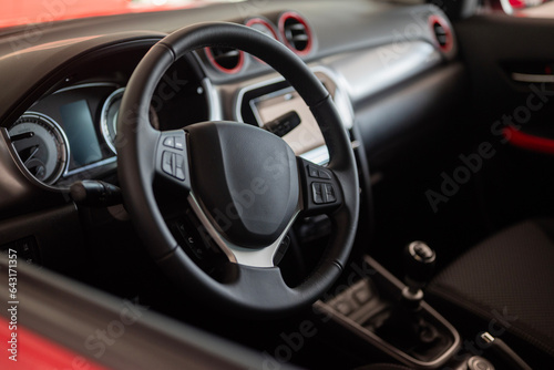 black steering wheel of a car for a driver driving a vehicle inside a car