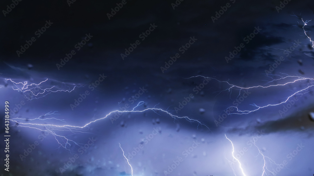 Lightning flashes in the night sky during a storm Lightning flashes in the night sky during a storm