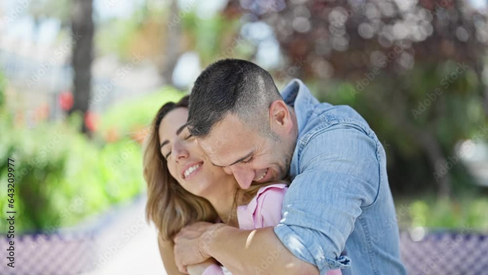 Man and woman couple hugging each other kissing at park Man and woman couple hugging each other kissing at park