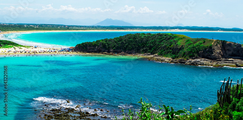 Top view of Praia das Conchas, close to the city of Cabo Frio, with white sand beaches, blue sky, sea with green waters, with mountains in the background - 120