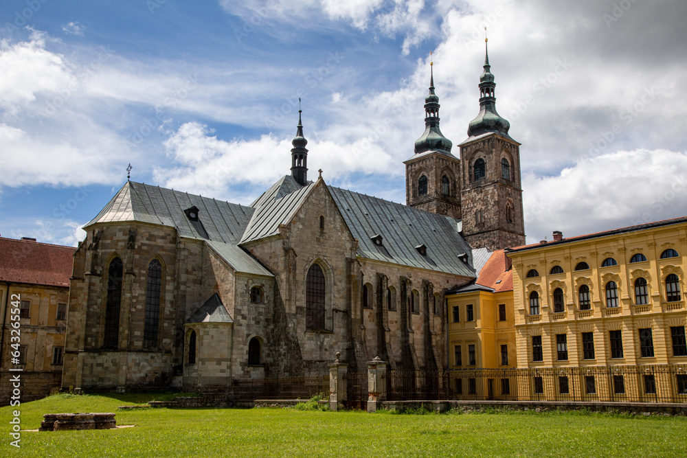 Naklejka premium Close-Up of Premonstratensian Monastery with Central Church, Green Lawn, Dramatic Stormy Clouds