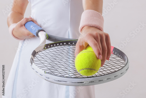 sports girl tennis player in a light uniform with a tennis racket on a clean background, the concept of tennis