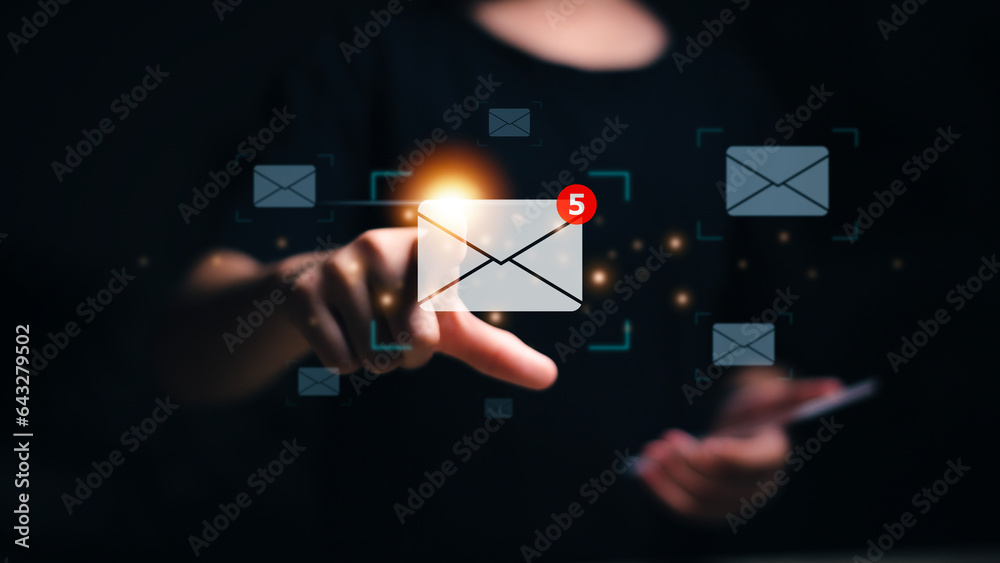 © FAMILY STOCK - New email notification concept. Woman touch on email in virtual screen. for business e-mail communication and digital marketing. Inbox receiving electronic message alert. Internet technology.