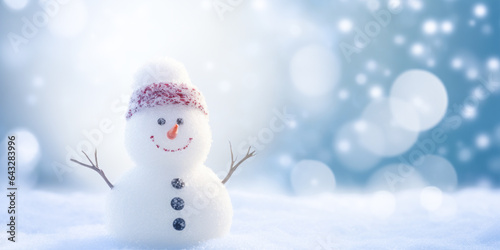 Snowman on snowy background with bokeh effect. Christmas card. © Marc Andreu