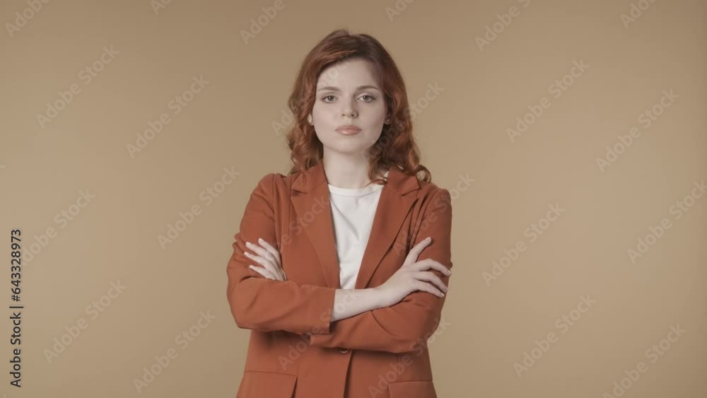 Medium isolated video of a satisfied, relaxed and calm young woman crossing her arms on to demonstrate seriousness and self-confidence. HDR BT2020 HLG Material. HDR BT2020 HLG Material. Medium isolated video of a satisfied, relaxed and calm young woman crossing her arms on to demonstrate seriousness and self-confidence. HDR BT2020 HLG Material. HDR BT2020 HLG Material.