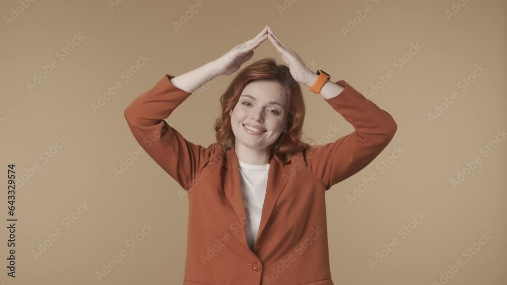 Medium isolated video of a dissatisfied, anxious and sad young woman holding hands over her head imitating a roof and looking from underneath it. HDR BT2020 HLG Material. HDR BT2020 HLG Material. Medium isolated video of a dissatisfied, anxious and sad young woman holding hands over her head imitating a roof and looking from underneath it. HDR BT2020 HLG Material. HDR BT2020 HLG Material.