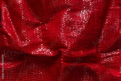 Foto Red woven plastic net for packaging fruits, vegetables, or products