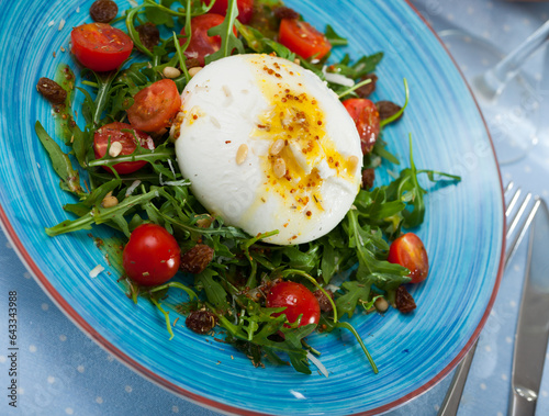 Burrata salad with arugula and tomatoes. High quality photo