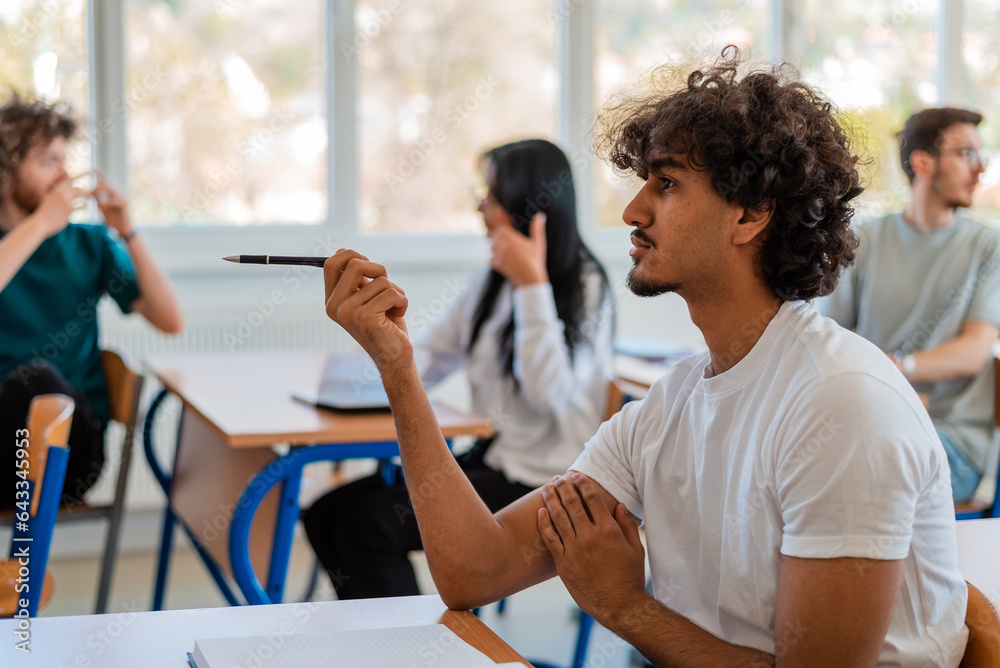 In the classroom group of college students are listening to a lecturer and are involved in the discussion. In the classroom group of college students are listening to a lecturer and are involved in the discussion.