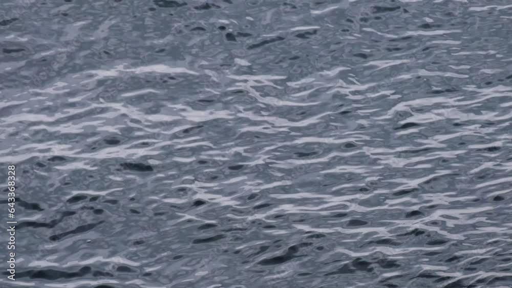Continuously changing disquiet blue sea or ocean surface for a background. Beautiful and fresh wavy water on a cloudy spring afternoon. Refreshing, abstract and minimalistic 4K slow motion. Continuously changing disquiet blue sea or ocean surface for a background. Beautiful and fresh wavy water on a cloudy spring afternoon. Refreshing, abstract and minimalistic 4K slow motion.
