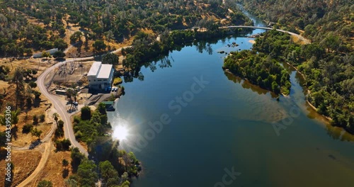 Beautiful scenery of the lake reflecting bright sun. Amazing panorama of Sierra National Forest, California, USA from aerial perspective. photo