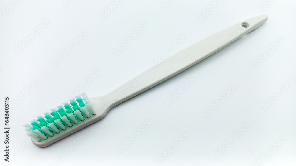 White Plastic Toothbrush Isolated On White Background. Tilted View From Above White Plastic Toothbrush Isolated On White Background. Tilted View From Above