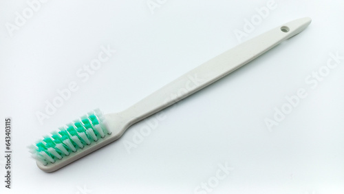 White Plastic Toothbrush Isolated On White Background. Tilted View From Above