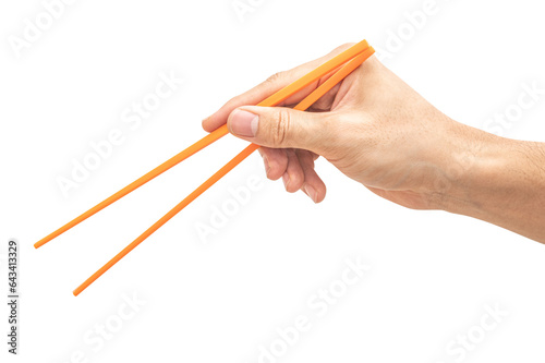 isolated of a man's hand holding a orange plastic chopstick.