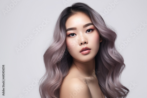 Portrait of Asian Beautiful supermodel woman with waving pink blonde hair, hair care and product concept. Colorful Dyed Hair. a Model with perfect Healthy Dyed Hair.