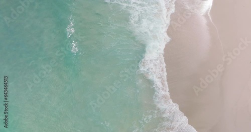 4K DCI 4096x2160p. Top-down view aerial beach video Ocean waves roll onto the beautiful beach. Filmed with high quality cinema cameras. DCI 4K ProRes422 photo