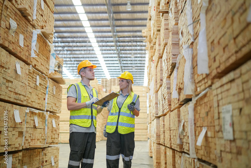фотографія Warehouse worker working at lumber yard in Large Warehouse