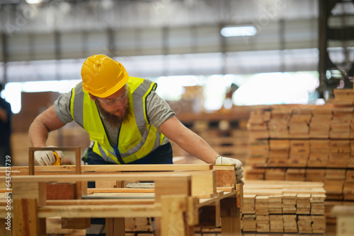 Industrial factory employee working in wooden manufacturing industry