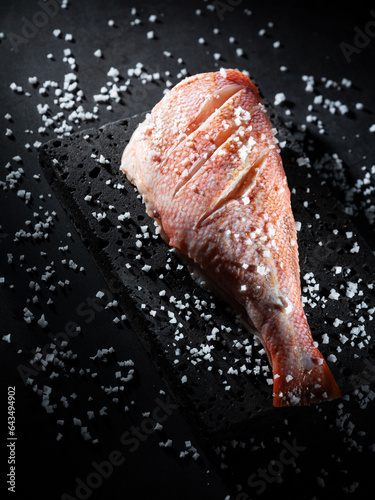 Red rockfish sprinkled with coarse salt photo