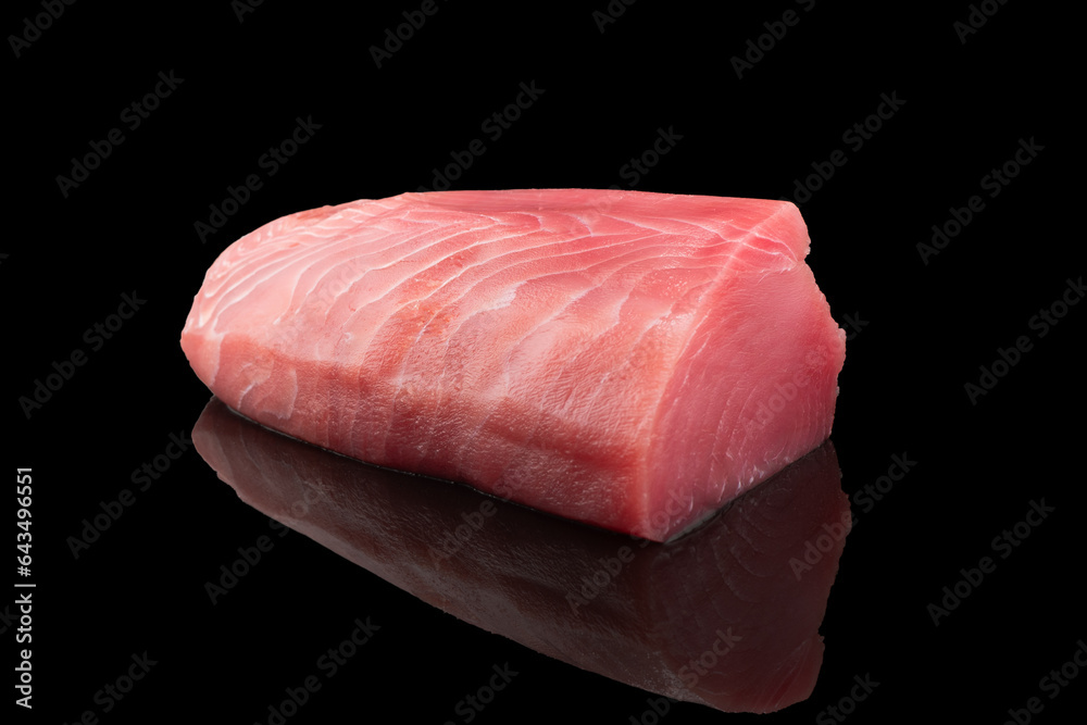 Yellow fin tuna steak isolated on black background. Fresh rare tuna steak isolated. Raw yellowfin tuna fillet texture. Background fresh fish meat. Top view of slices of tuna meat. - obrazy, fototapety, plakaty 