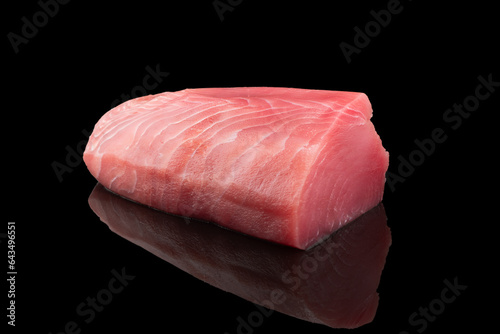 Yellow fin tuna steak isolated on black background. Fresh rare tuna steak isolated. Raw yellowfin tuna fillet texture. Background fresh fish meat. Top view of slices of tuna meat. photo