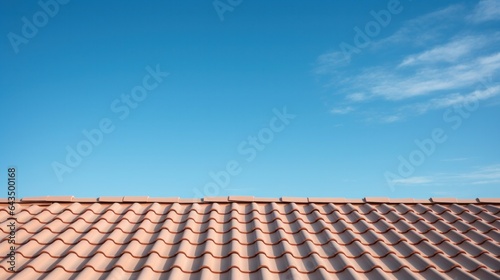 Abstract of a section of roof on a resedential house with clear blue sky background. photo