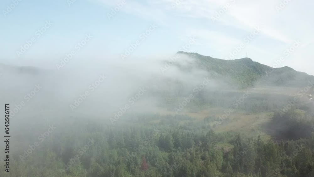 Clouds overflowing a mountain on ridge of st-laurence river in Gaspesie Quebec Canada Clouds overflowing a mountain on ridge of st-laurence river in Gaspesie Quebec Canada