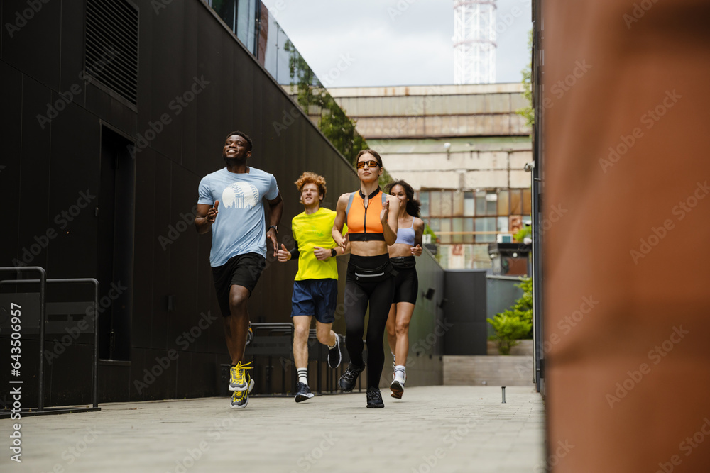 Fototapeta premium Group of people running along city street