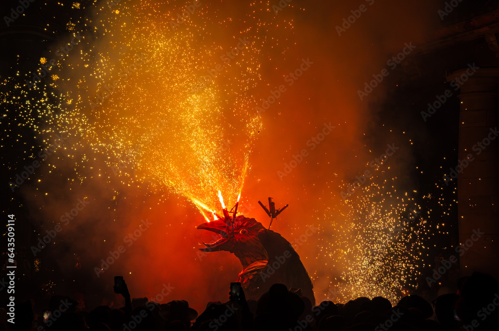 Dragon in profile with its mouth open and sticking out its tongue