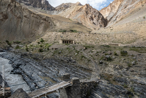 Trekking past an abandoned village along the Tsarab Chu River in Zanskar, Ladakh, India