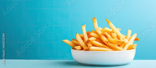 Delicious fries on pale blu...