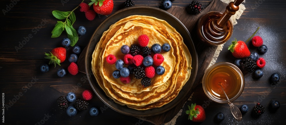 Fruity pancakes with honey on a dark background Fruity pancakes with honey on a dark background