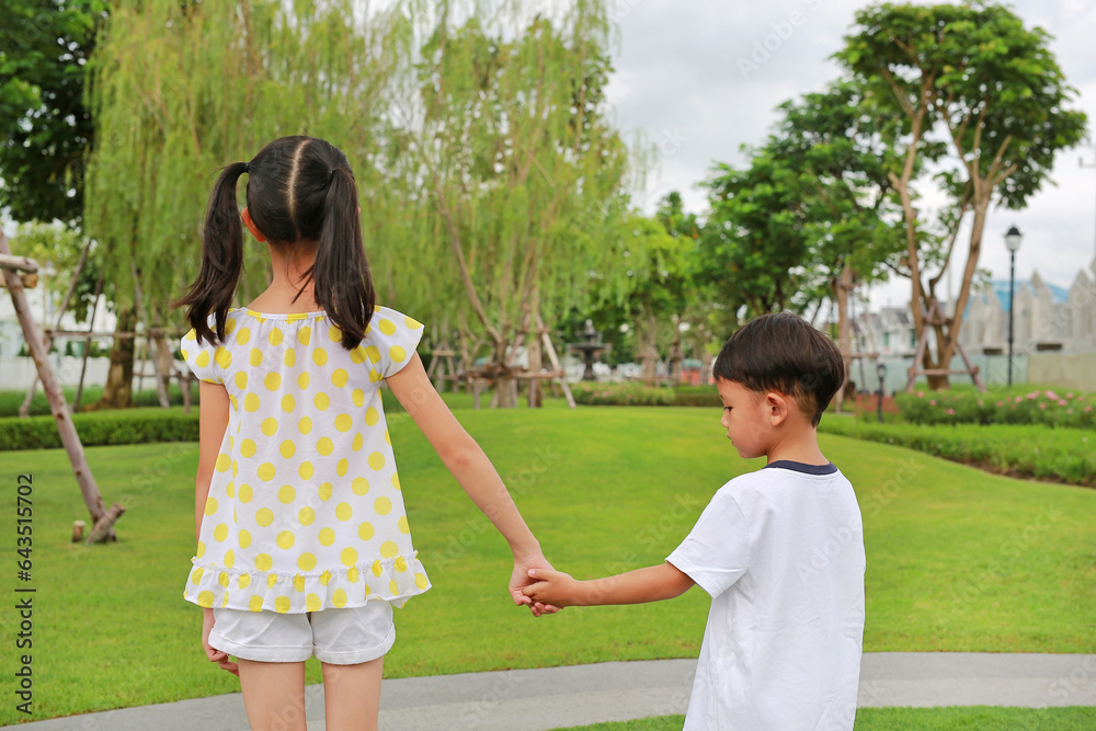 Asian little boy and girl child with hand in hand while play together ...