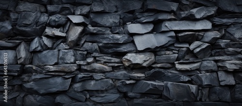 Texture and pile of rocks in a black stone background on a wall surface
