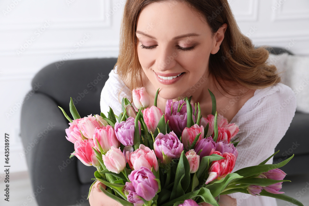 Young woman with bouquet of beautiful tulips indoors Young woman with bouquet of beautiful tulips indoors