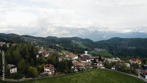 Aerial view soaring over Soprabolzano in Italy's mountainous countryside. photo